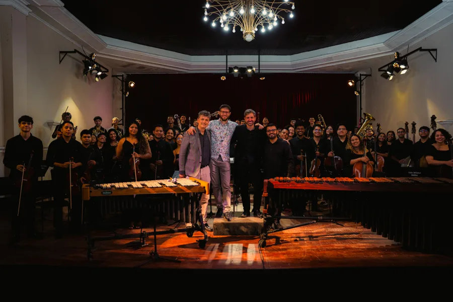 The orchestra, conductor, soloist and composer on stage after the premiere